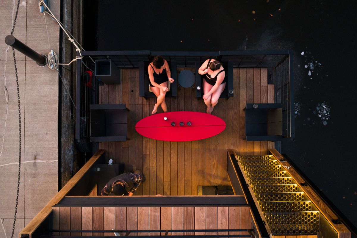floating sauna with two people sitting on it