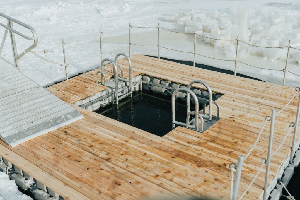 cold plunge sunk in a deck surrounded by ice
