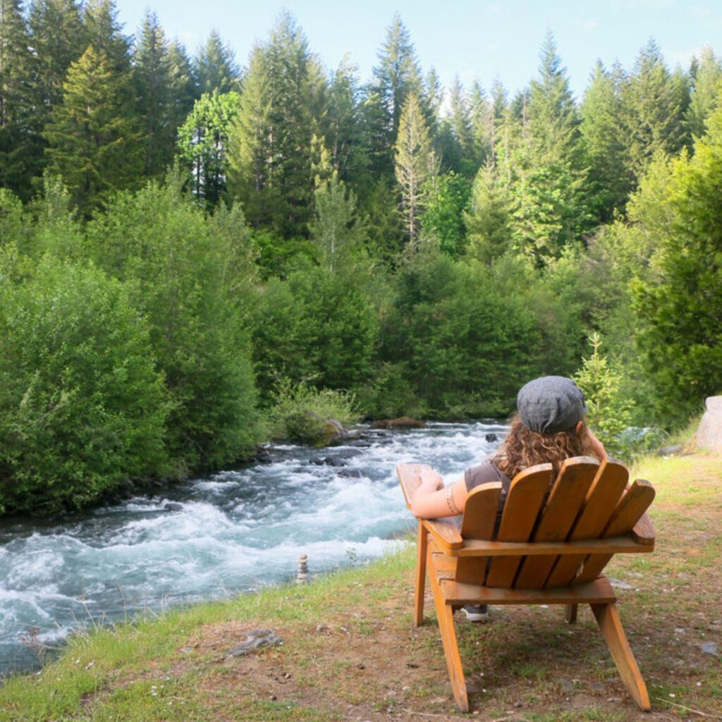 person overlooking the river at breitenbush