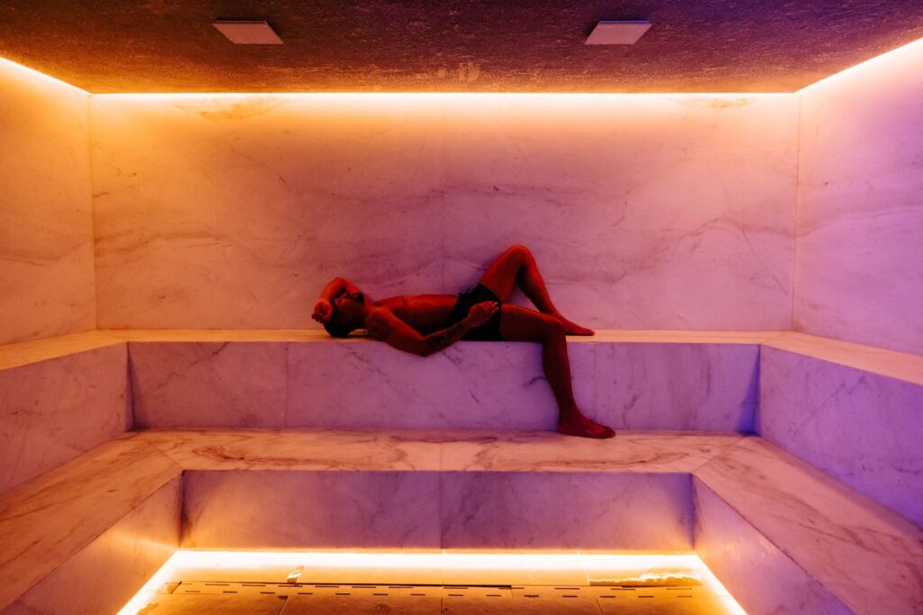 man lounging in steam room